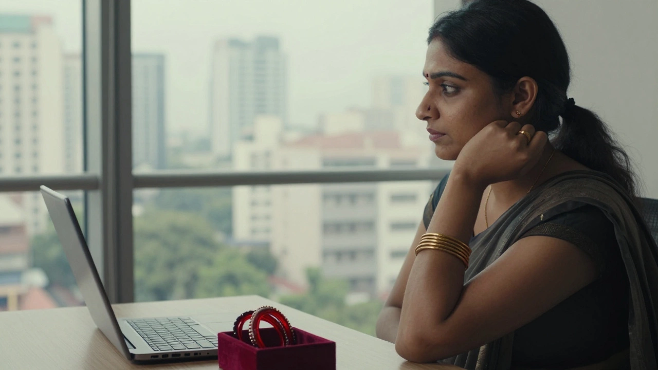 A modern woman in an office wearing a red bindi and gold bangles, with traditional bangles in a velvet box.